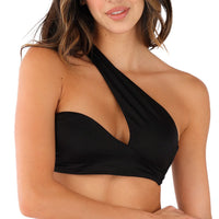 A woman wearing the Sofia One Shoulder Bikini Top exudes a high-fashion edge from shoulders to waist. Her long, wavy hair and slight smile enhance the look against the plain white background.