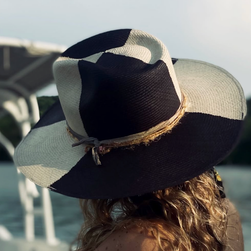 Person wearing a black and white striped hat with a blurred background