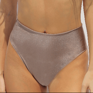 Against a neutral background, a person stands wearing the Vida High Waisted Bikini Bottom, crafted with a shiny metallic finish and handmade in Italy. The focus is on the exquisite texture and style of this piece, part of an exclusive swimwear collection.